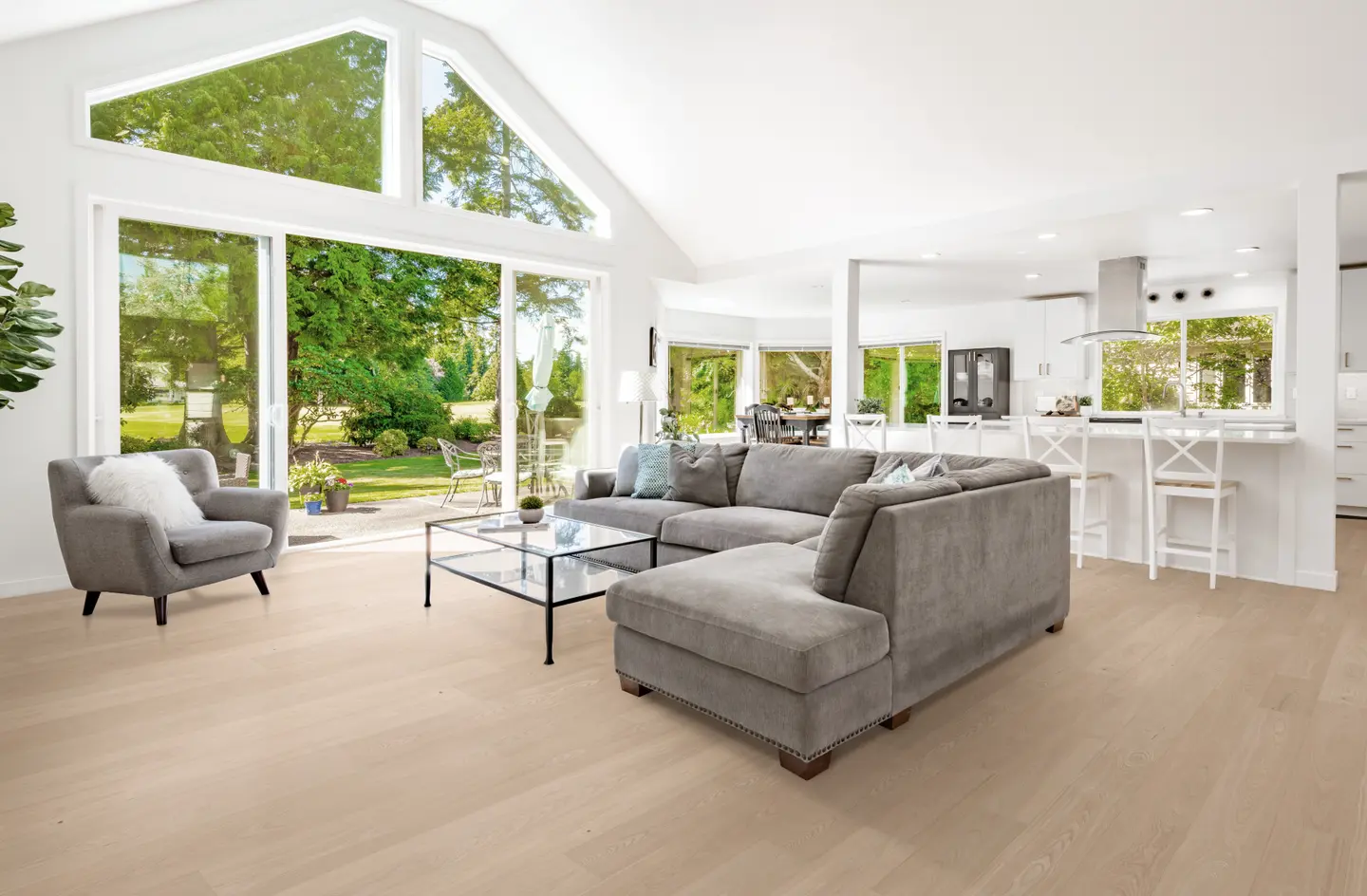 Clarified Ash hardwood flooring in an Orlando home — light wood grain that shows grit abrasion and rug-pad marks clearly