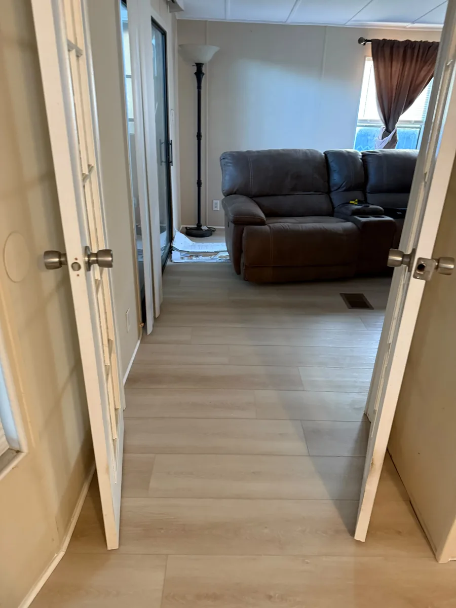 Completed vinyl flooring through a Winter Garden entry hallway and living room