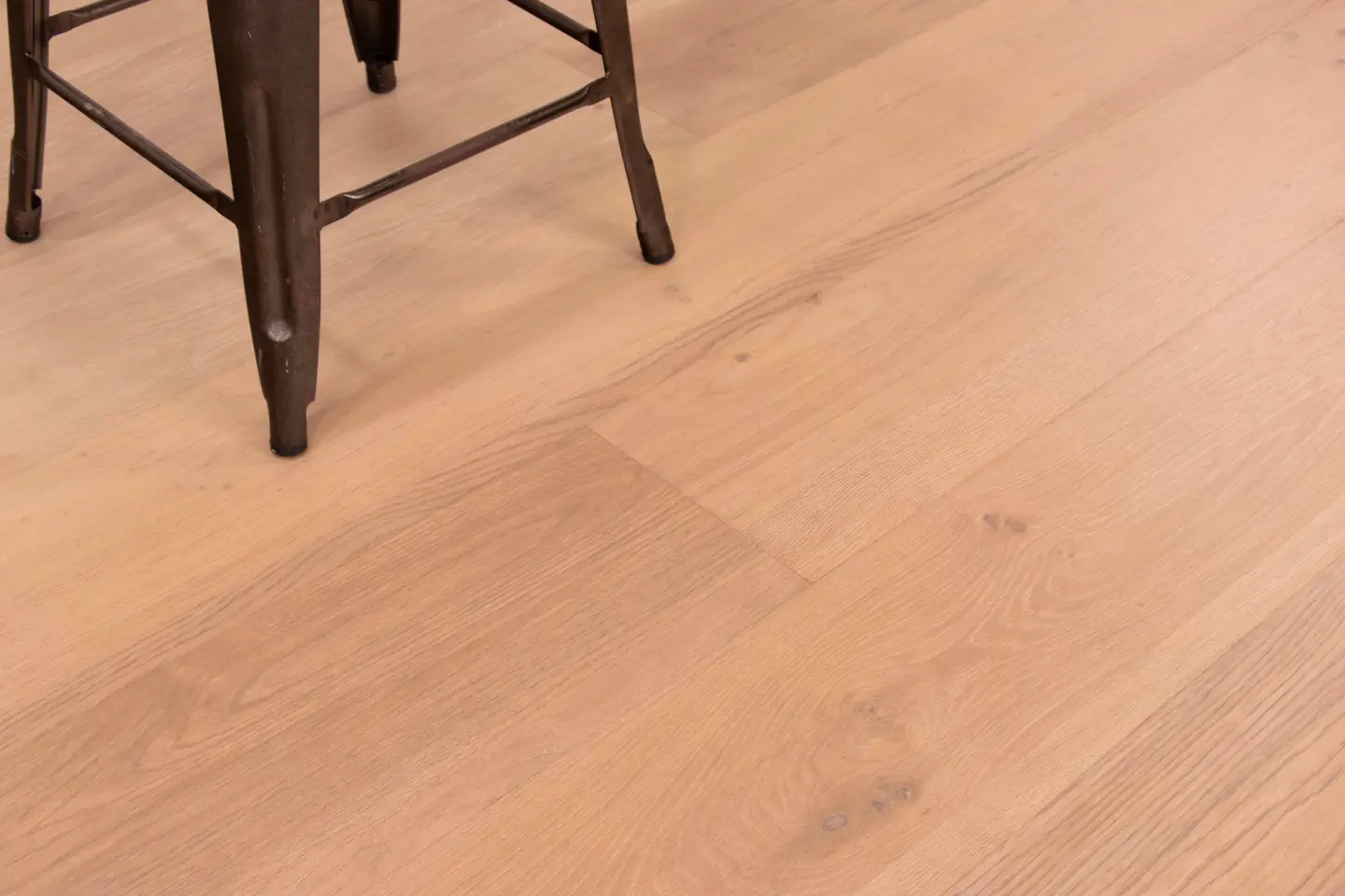 Capitola Caramel laminate plank close-up showing precision click-lock tongue and groove joint for mid-room replacement